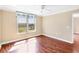 Bright bedroom featuring hardwood floors, a ceiling fan, and a large window with a view of the grounds at 3750 Pinebrook Circle # Apt 505, Bradenton, FL 34209