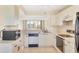 Bright kitchen features white cabinets, a stainless steel sink, and modern appliances, offering a functional space at 3750 Pinebrook Circle # Apt 505, Bradenton, FL 34209