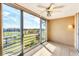 Enclosed lanai with sliding glass doors offering views of the green golf course and blue skies at 3750 Pinebrook Circle # Apt 505, Bradenton, FL 34209
