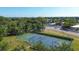 Aerial shot features a tennis court amidst lush green foliage, providing an idyllic spot for recreational play at 3750 Pinebrook Circle # Apt 505, Bradenton, FL 34209