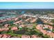 A picturesque aerial shot of the community showcases lakes, a pool, and tennis courts at 3825 Wilshire Cir # 1, Sarasota, FL 34238