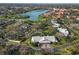 An aerial view of a lovely single-Gathering home with mature trees and a beautiful lake view at 3825 Wilshire Cir # 1, Sarasota, FL 34238