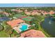 Beautiful aerial view of community with tennis courts, pool, and access to water at 3825 Wilshire Cir # 1, Sarasota, FL 34238