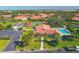 Aerial view of a community clubhouse with a pool and tennis courts at 3825 Wilshire Cir # 1, Sarasota, FL 34238