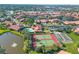 Scenic aerial shot of a housing community featuring tennis courts and a pool at 3825 Wilshire Cir # 1, Sarasota, FL 34238