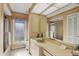 Bright bathroom featuring a double sink vanity, floral wallpaper, and modern fixtures at 3825 Wilshire Cir # 1, Sarasota, FL 34238