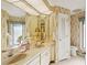 Well-lit bathroom featuring a double sink vanity, floral wallpaper, and modern fixtures at 3825 Wilshire Cir # 1, Sarasota, FL 34238