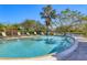 Sparkling community pool offers a refreshing escape, surrounded by lush greenery and palm trees at 3825 Wilshire Cir # 1, Sarasota, FL 34238