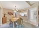 Traditional dining room with chandelier, neutral paint, and carpet flooring at 3825 Wilshire Cir # 1, Sarasota, FL 34238