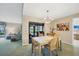 Inviting dining area with chandelier and sliding doors opening to a screened lanai at 3825 Wilshire Cir # 1, Sarasota, FL 34238