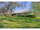 Well-manicured lawn and landscaping surround this home with neutral exterior and dark-framed windows at 3825 Wilshire Cir # 1, Sarasota, FL 34238