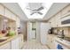 Bright kitchen featuring white cabinets, modern appliances, and tile flooring at 3825 Wilshire Cir # 1, Sarasota, FL 34238