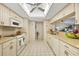 Bright eat-in kitchen with white cabinetry, tile backsplash, and updated appliances at 3825 Wilshire Cir # 1, Sarasota, FL 34238