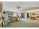 Open-concept living room with high ceilings, dining area, and sliding door access to the lanai at 3825 Wilshire Cir # 1, Sarasota, FL 34238