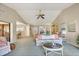 Comfortable living room with vaulted ceiling, neutral paint, and open layout to dining and kitchen at 3825 Wilshire Cir # 1, Sarasota, FL 34238