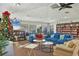 Bright community lounge area with comfortable seating, bookshelves, and a festive Christmas tree at 3825 Wilshire Cir # 1, Sarasota, FL 34238
