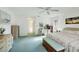 Bright main bedroom featuring green carpet, a ceiling fan, and ample natural light at 3825 Wilshire Cir # 1, Sarasota, FL 34238