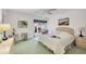 Bright bedroom featuring soft carpet, comfortable bed, and large windows with greenery views at 3825 Wilshire Cir # 1, Sarasota, FL 34238