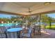 Inviting poolside patio with tables, chairs, and scenic views of the lake at 3825 Wilshire Cir # 1, Sarasota, FL 34238