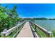 Picturesque wooden dock leading out to a serene lake, offering scenic views of the surrounding property at 3829 Lake Bayshore Dr # 511, Bradenton, FL 34205