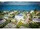 Beautiful aerial view of waterfront homes, palm trees, and a canal on a sunny day with a blue sky at 401 20Th Pl, Bradenton Beach, FL 34217