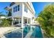 Stylish raised beach home showcases a pool, well-manicured landscaping and great backyard entertaining space at 401 20Th Pl, Bradenton Beach, FL 34217