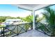 Enjoy the canal view from this home's cozy balcony, surrounded by tropical foliage, with outdoor living at 401 20Th Pl, Bradenton Beach, FL 34217