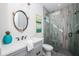 Modern bathroom featuring a vanity with sink, decorative mirror, and glass-enclosed shower at 401 20Th Pl, Bradenton Beach, FL 34217