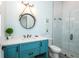Updated bathroom featuring a teal vanity with white countertops and a glass shower at 401 20Th Pl, Bradenton Beach, FL 34217