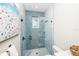 Updated bathroom showcasing glass shower with blue mosaic tiling and rain shower head at 401 20Th Pl, Bradenton Beach, FL 34217