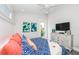 Bedroom featuring a ceiling fan, colorful bedding, coastal decor, and a flatscreen TV at 401 20Th Pl, Bradenton Beach, FL 34217