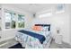 Comfortable bedroom featuring a bed with a patterned comforter, throw pillows, and natural light from windows at 401 20Th Pl, Bradenton Beach, FL 34217