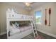 Bedroom featuring a white bunk bed, ceiling fan and window with a waterfront view at 401 20Th Pl, Bradenton Beach, FL 34217