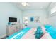 Bedroom with a flatscreen TV, coastal decor and balcony access for a beachy feel at 401 20Th Pl, Bradenton Beach, FL 34217