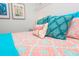 Close-up of a stylish bedroom featuring turquoise and coral bedding and flamingo accents at 401 20Th Pl, Bradenton Beach, FL 34217