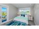 Bedroom with a balcony, area rug, and water views from two windows at 401 20Th Pl, Bradenton Beach, FL 34217