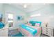 Bright bedroom with a ceiling fan, balcony access, and colorful coastal-themed decor at 401 20Th Pl, Bradenton Beach, FL 34217