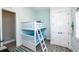 Bunk bedroom with white bunk beds and a blue patterned comforter, alongside a closet and a window at 401 20Th Pl, Bradenton Beach, FL 34217
