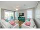Bright living room featuring stylish furniture, colorful decor, and sliding doors to the outdoor balcony at 401 20Th Pl, Bradenton Beach, FL 34217