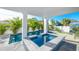 Backyard pool with hot tub features a stylish tile design and lush greenery, perfect for relaxing in your own private oasis at 401 20Th Pl, Bradenton Beach, FL 34217