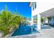 Inviting backyard pool features cool, blue tile and a spacious deck, perfect for relaxation and outdoor entertaining at 401 20Th Pl, Bradenton Beach, FL 34217