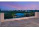 Balcony view overlooking tranquil water with lush greenery, offering a peaceful and picturesque setting at 4205 Higel Ave, Sarasota, FL 34242