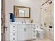 Bathroom featuring a white vanity, a large mirror, and a shower with marble tile at 4205 Higel Ave, Sarasota, FL 34242