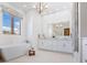 Bright bathroom with double vanity, large mirror, soaking tub, and a window at 4205 Higel Ave, Sarasota, FL 34242