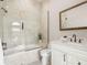 Light-filled bathroom with tiled shower-tub combo and a sleek white vanity at 4205 Higel Ave, Sarasota, FL 34242
