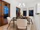 Elegant dining room featuring a round table, white chairs, and natural light from a large window at 4205 Higel Ave, Sarasota, FL 34242