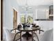 Charming dining room with a round table, stylish chairs, and views of the outdoor greenery at 4205 Higel Ave, Sarasota, FL 34242