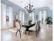 Elegant dining room with blue walls, large windows, and stylish chandelier, perfect for entertaining at 4205 Higel Ave, Sarasota, FL 34242