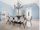 Elegant dining room featuring a decorative chandelier, seating for eight, and light blue walls at 4205 Higel Ave, Sarasota, FL 34242