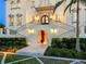 Elegant home entrance with staircase, accent lighting, and manicured landscaping at 4205 Higel Ave, Sarasota, FL 34242